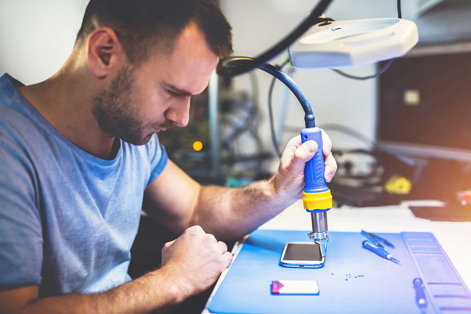 man-repairing-smartphone-at-workplace-2022-03-04-05-57-51-utc.jpg